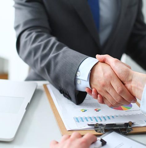 Business handshake. Business people shaking hands, finishing up a meeting